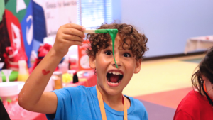slime, wacky science kid, kid playing and smiling, communities, day camps kid, bucket list
