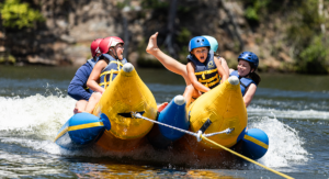 family on banana boat at one-week session at family camp